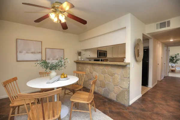 a kitchen with stainless steel appliances kitchen island granite countertop a sink and chairs