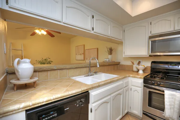 a kitchen with a sink cabinets and stainless steel appliances