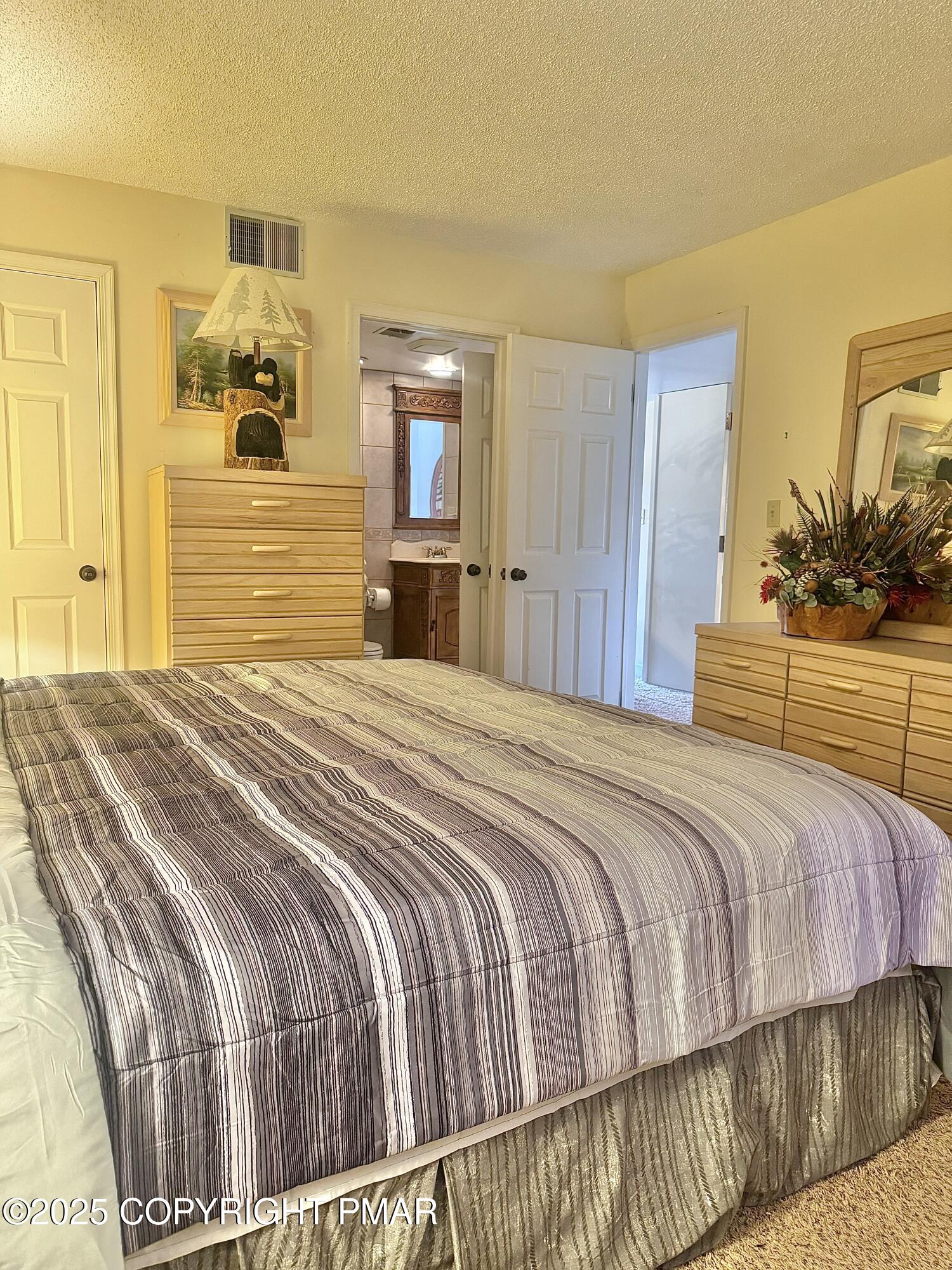 33 Midlake Drive, Unit 101 Lake Harmony, PA 18624 - Photo 15 of 39 a bedroom with a bed and mirror