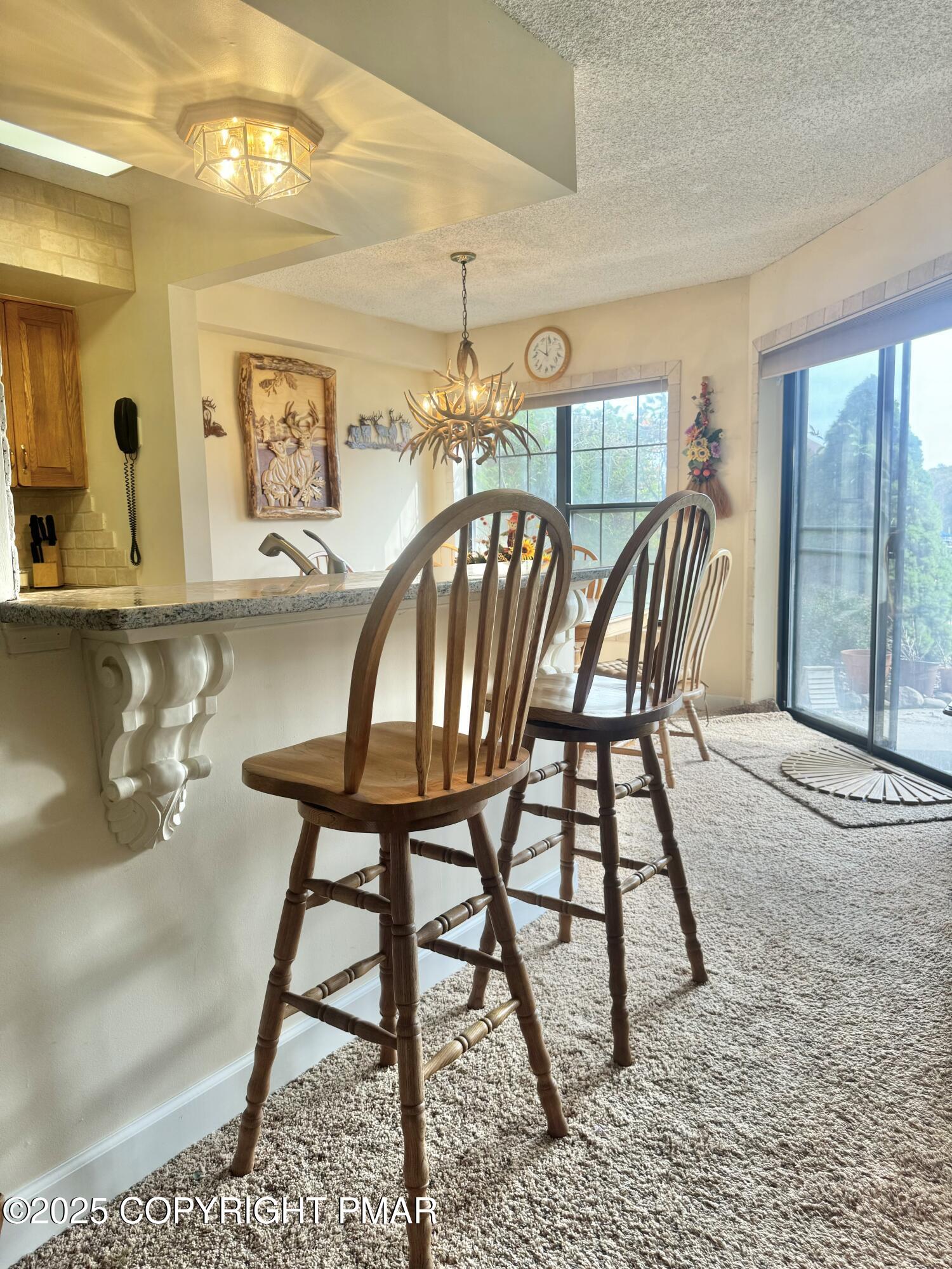 33 Midlake Drive, Unit 101 Lake Harmony, PA 18624 - Photo 22 of 39 a view of a dining room with furniture and a chandelier