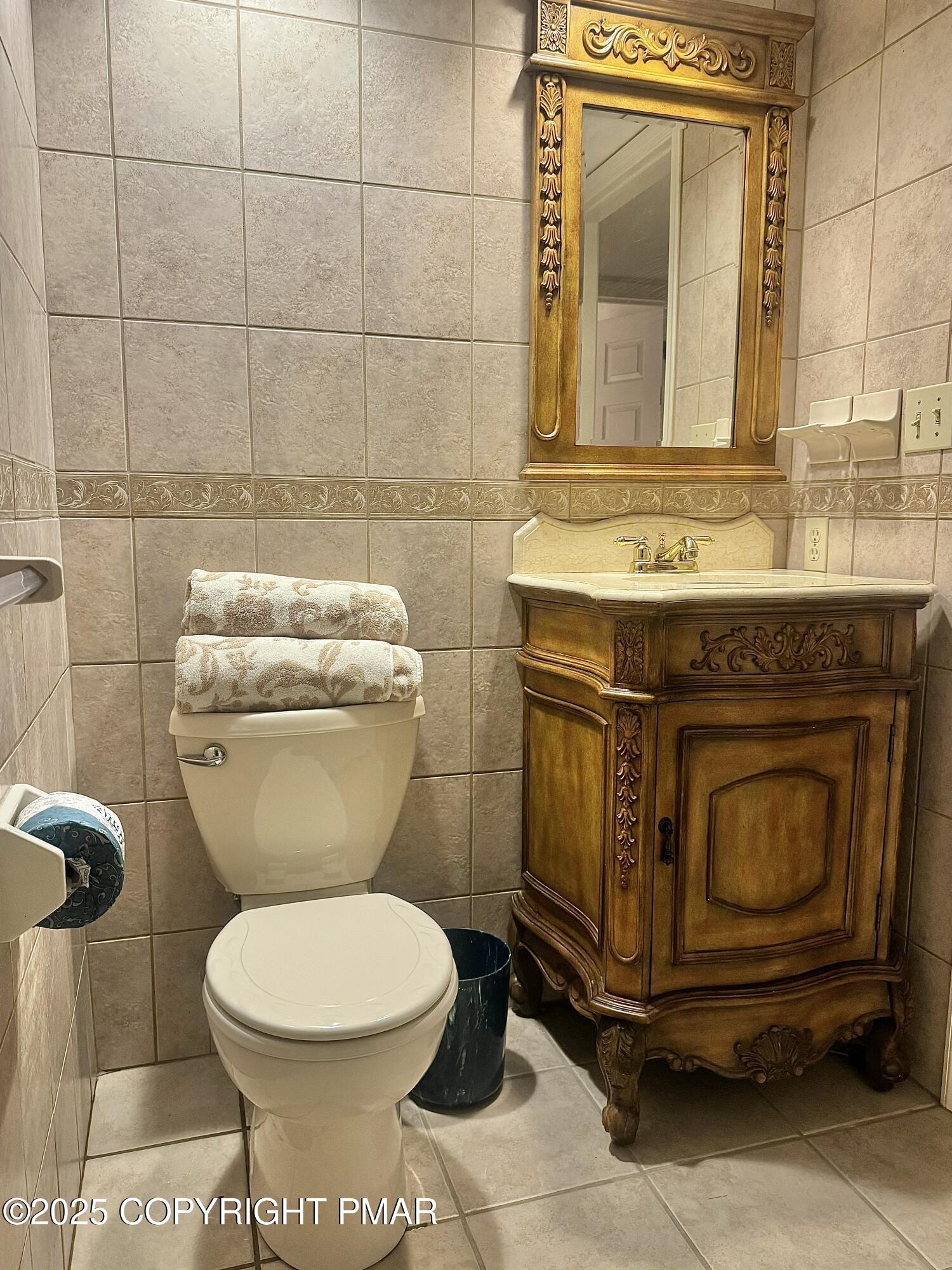 33 Midlake Drive, Unit 101 Lake Harmony, PA 18624 - Photo 5 of 39 a bathroom with a toilet a sink and mirror