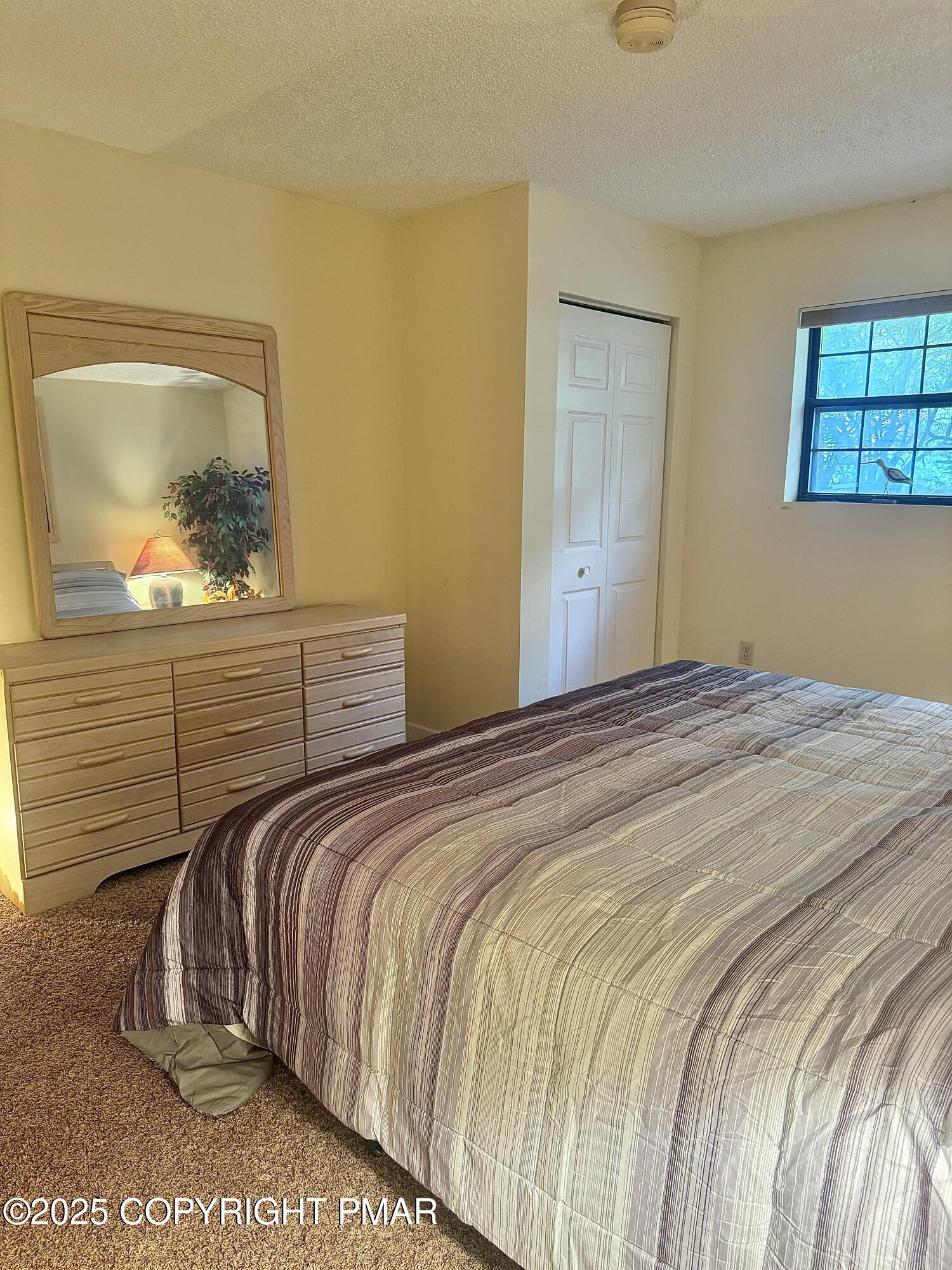 33 Midlake Drive, Unit 101 Lake Harmony, PA 18624 - Photo 8 of 39 a bedroom with a bed and a painting on the wall