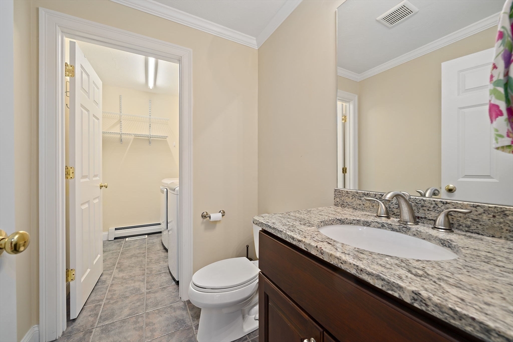 14 Sugar Maple Circle, Unit 14 Hanover, MA 02339 - Photo 14 of 38 a bathroom with a granite countertop sink a toilet and shower