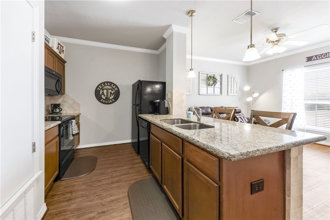 1198 Jones-Butler Road, Unit 1806 College Station, TX 77840 - Photo 13 of 26 a kitchen with a sink and a refrigerator