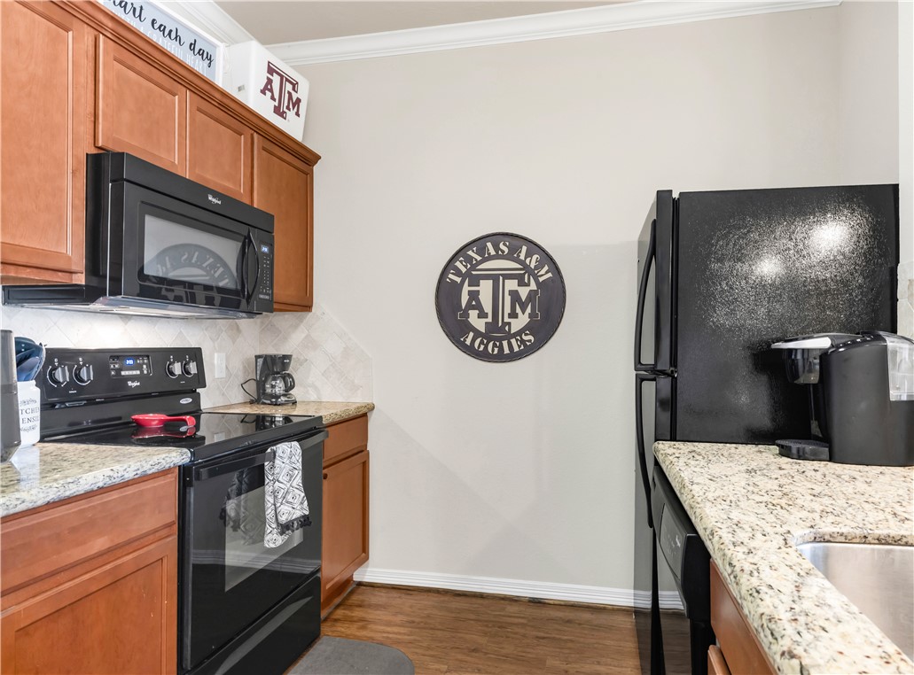 1198 Jones-Butler Road, Unit 1806 College Station, TX 77840 - Photo 15 of 26 a kitchen with a stove and a microwave