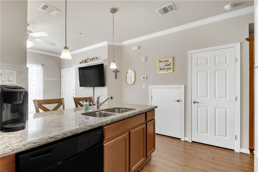 1198 Jones-Butler Road, Unit 1806 College Station, TX 77840 - Photo 18 of 26 a kitchen with stainless steel appliances granite countertop a sink a stove and a wooden floor
