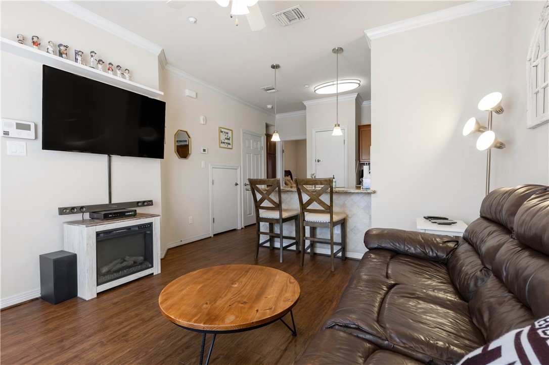 1198 Jones-Butler Road, Unit 1806 College Station, TX 77840 - Photo 2 of 26 a living room with furniture and a flat screen tv