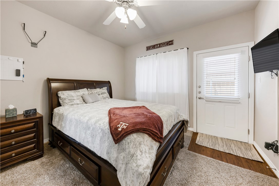 1198 Jones-Butler Road, Unit 1806 College Station, TX 77840 - Photo 21 of 26 a bedroom with a bed and a chandelier