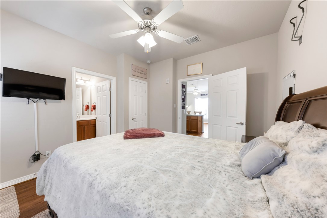 1198 Jones-Butler Road, Unit 1806 College Station, TX 77840 - Photo 22 of 26 a bedroom with a bed window and a flat screen tv