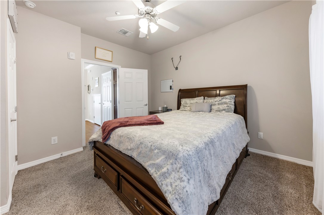 1198 Jones-Butler Road, Unit 1806 College Station, TX 77840 - Photo 4 of 26 a bedroom with a bed and a chandelier