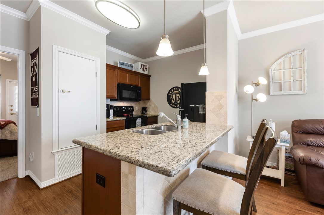 1198 Jones-Butler Road, Unit 1806 College Station, TX 77840 - Photo 9 of 26 a view of kitchen and dining area with furniture