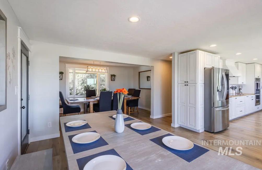 12170 Chinden Rdg Drive Boise, ID 83714 - Photo 11 of 47 Dining space featuring light wood-style flooring and recessed lighting
