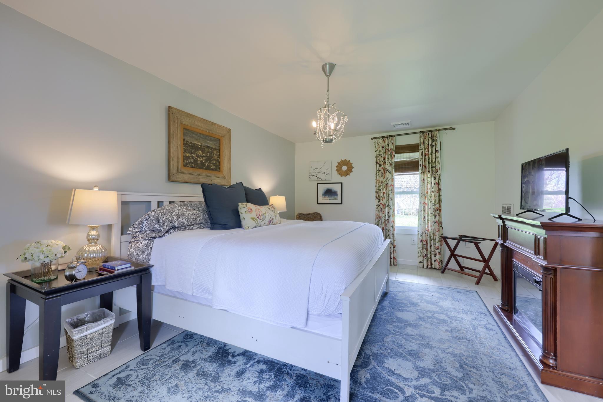 1770 Windy Hill Road Lancaster, PA 17602 - Photo 22 of 43 a bedroom with bed and a chandelier