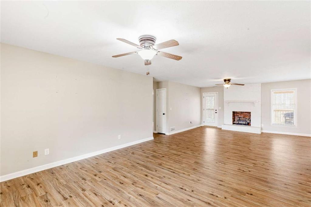 616 Wells Road Buchanan, GA 30113 - Photo 11 of 44 a view of empty room with wooden floor and fan