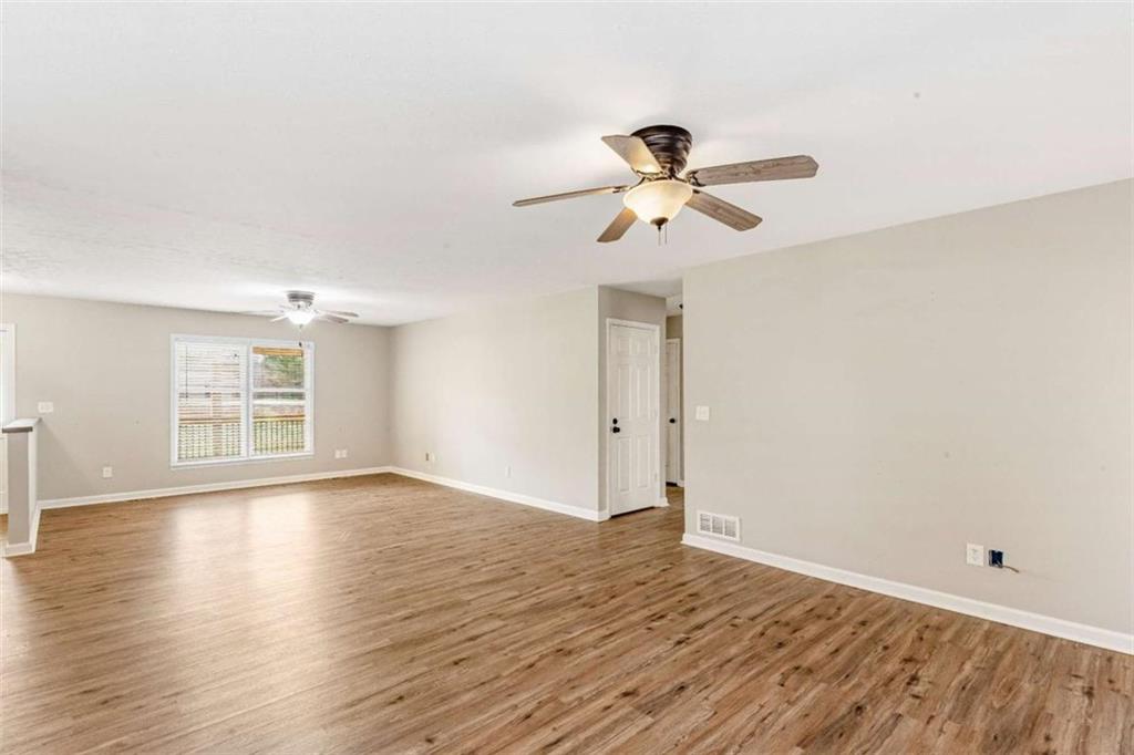 616 Wells Road Buchanan, GA 30113 - Photo 12 of 44 a view of empty room with wooden floor and fan