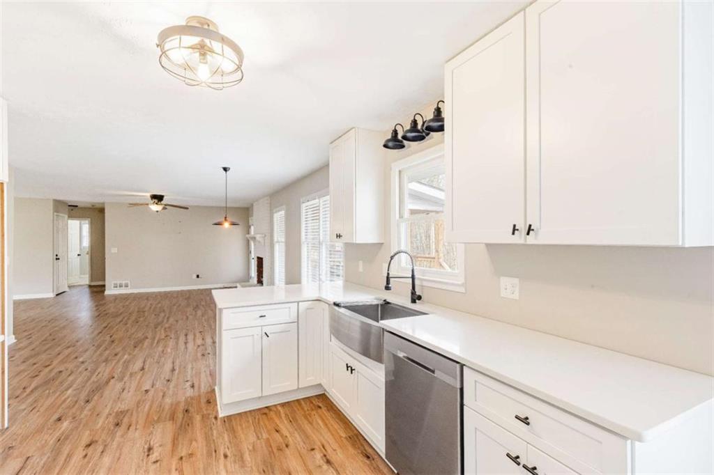 616 Wells Road Buchanan, GA 30113 - Photo 17 of 44 a kitchen with a sink cabinets and wooden floor