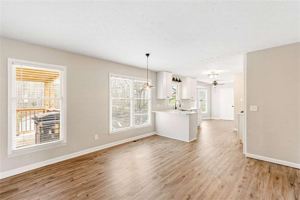 616 Wells Road Buchanan, GA 30113 - Photo 19 of 44 a large room with wooden floor and windows