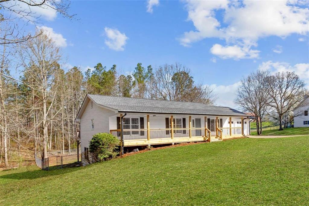 616 Wells Road Buchanan, GA 30113 - Photo 2 of 44 a view of a house with garden and trees