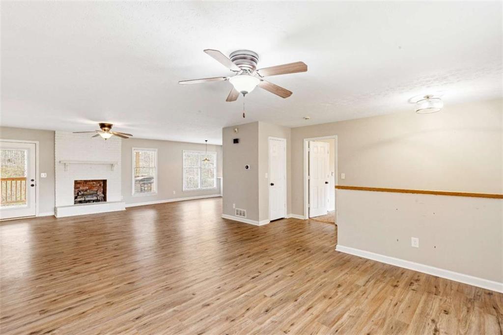 616 Wells Road Buchanan, GA 30113 - Photo 5 of 44 a view of an empty room with window and wooden floor