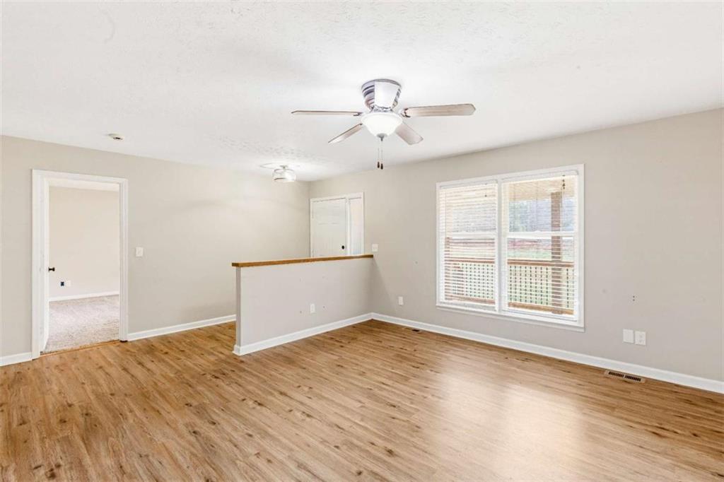 616 Wells Road Buchanan, GA 30113 - Photo 9 of 44 a view of empty room with wooden floor and ceiling fan
