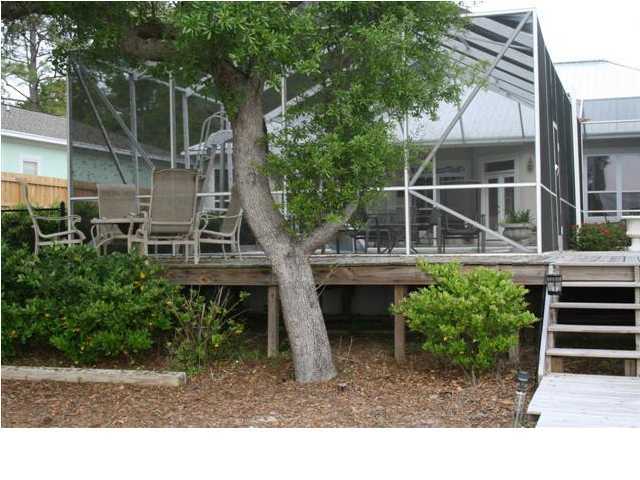 2188 Bay Grove Road Freeport, FL 32439 - Photo 22 of 23 a backyard of a house with outdoor seating and trees