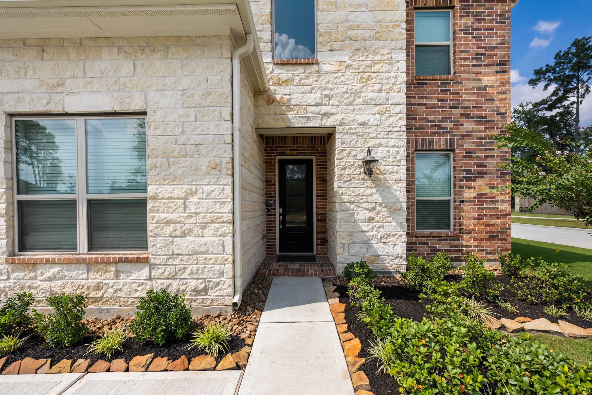 22014 Gateway Arch Drive Porter, TX 77365 - Photo 2 of 27 a stone house with potted plants in front of door