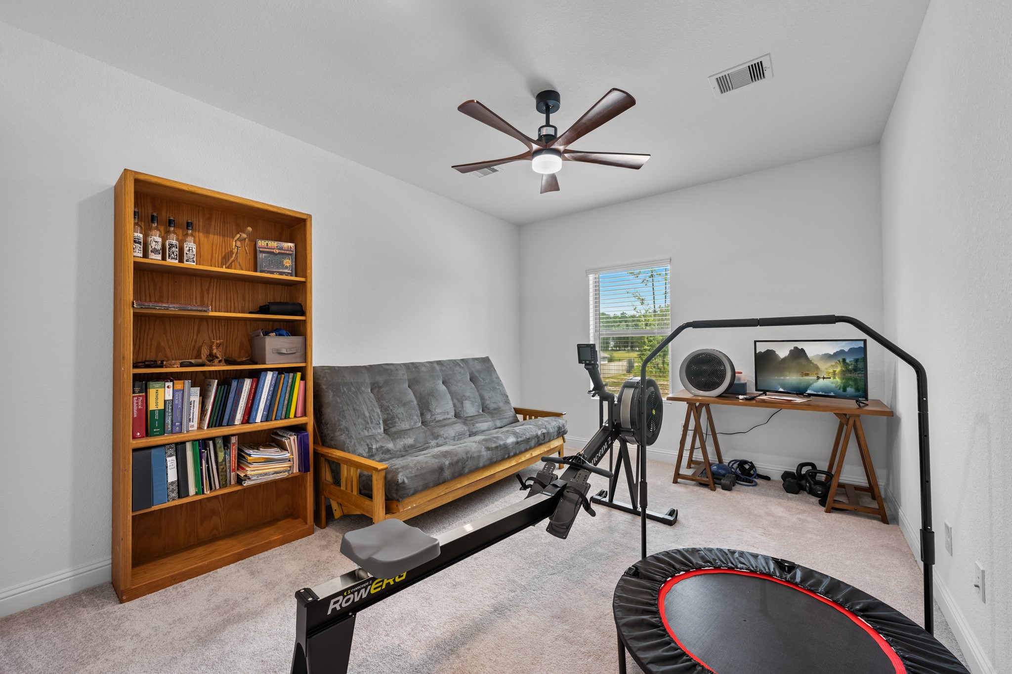 22014 Gateway Arch Drive Porter, TX 77365 - Photo 23 of 27 a living room with furniture and a book shelf