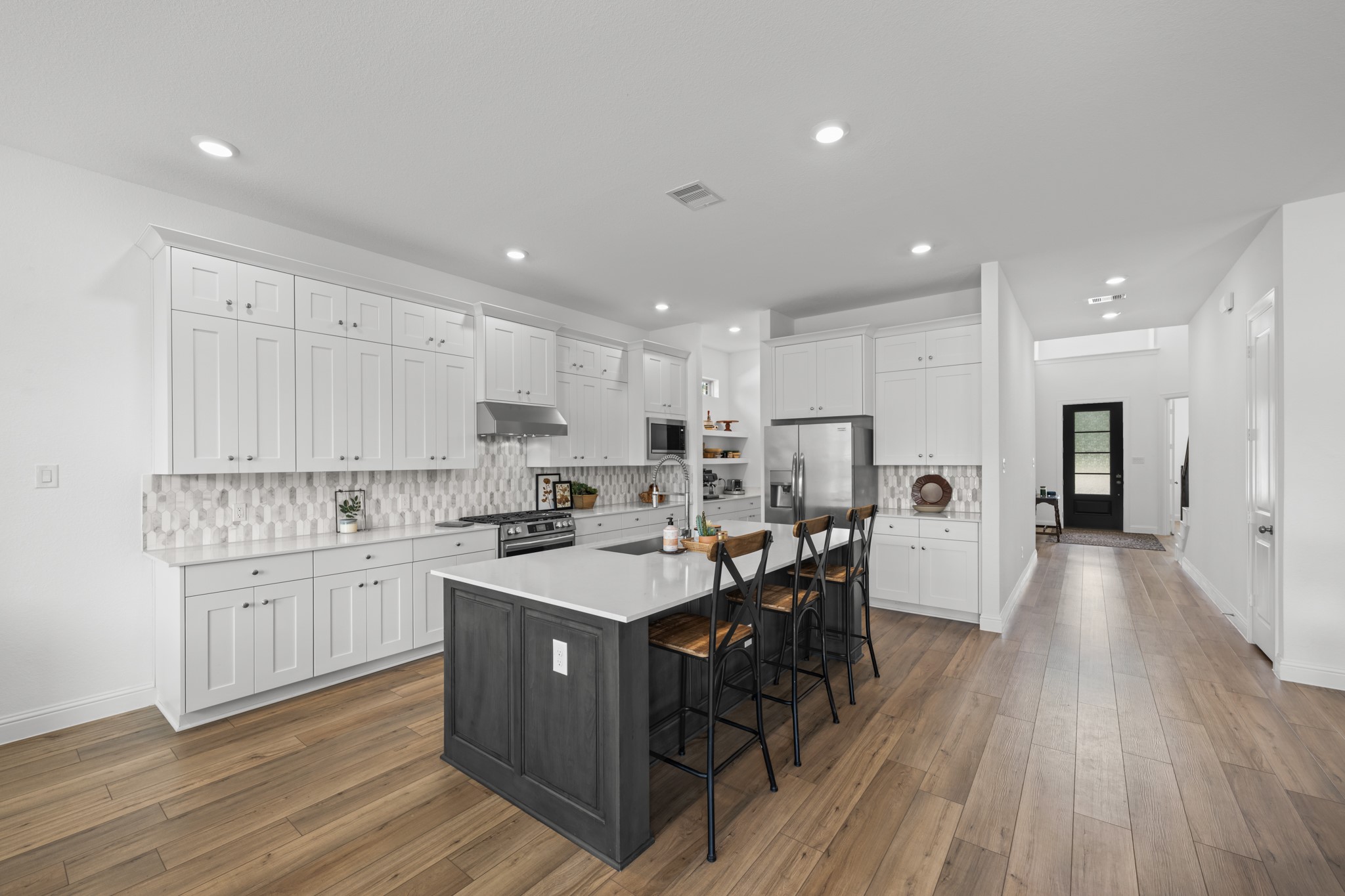 22014 Gateway Arch Drive Porter, TX 77365 - Photo 9 of 27 a kitchen with a sink a center island cabinets and stainless steel appliances