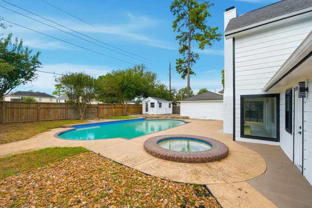 a view of swimming pool with a patio