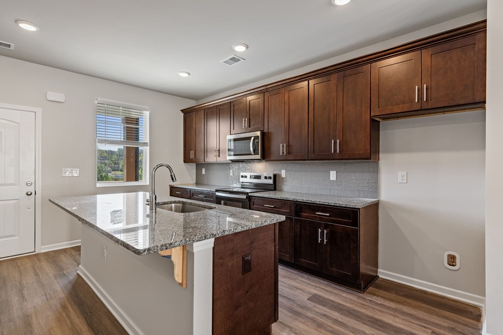 48 Grove Loop Blue Ridge, GA 30513 - Photo 21 of 27 a kitchen with stainless steel appliances granite countertop a sink stove and microwave