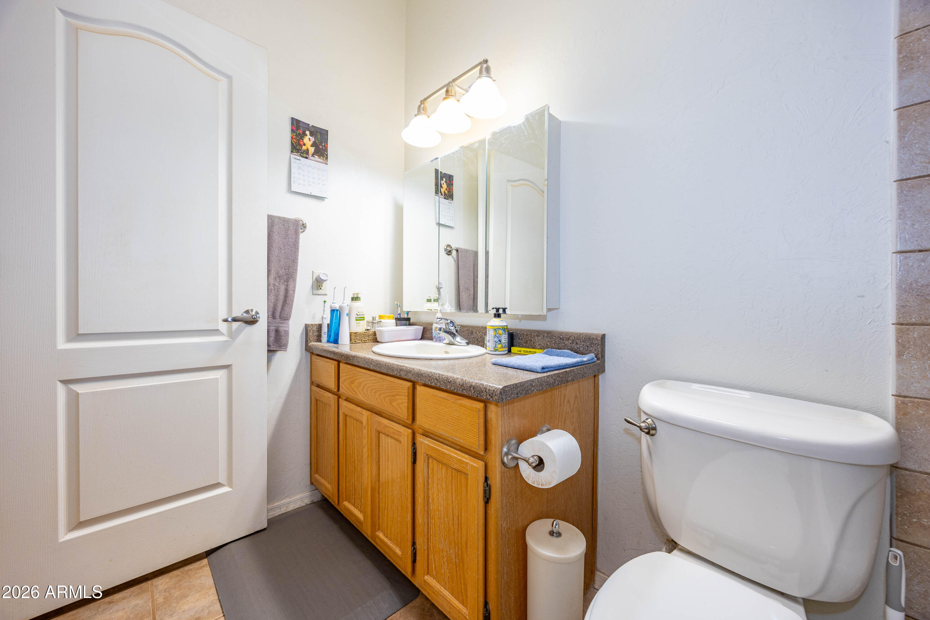 4575 South Kino Road Sierra Vista, AZ 85650 - Photo 25 of 25 a bathroom with a toilet sink and mirror
