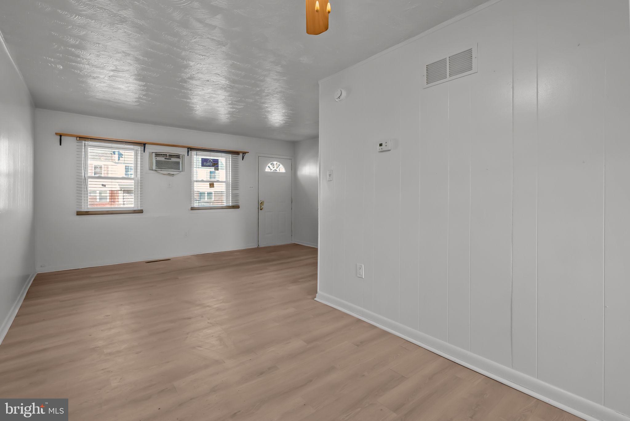 5708 Mitchell Road Levittown, PA 19057 - Photo 12 of 23 wooden floor in an empty room with a window