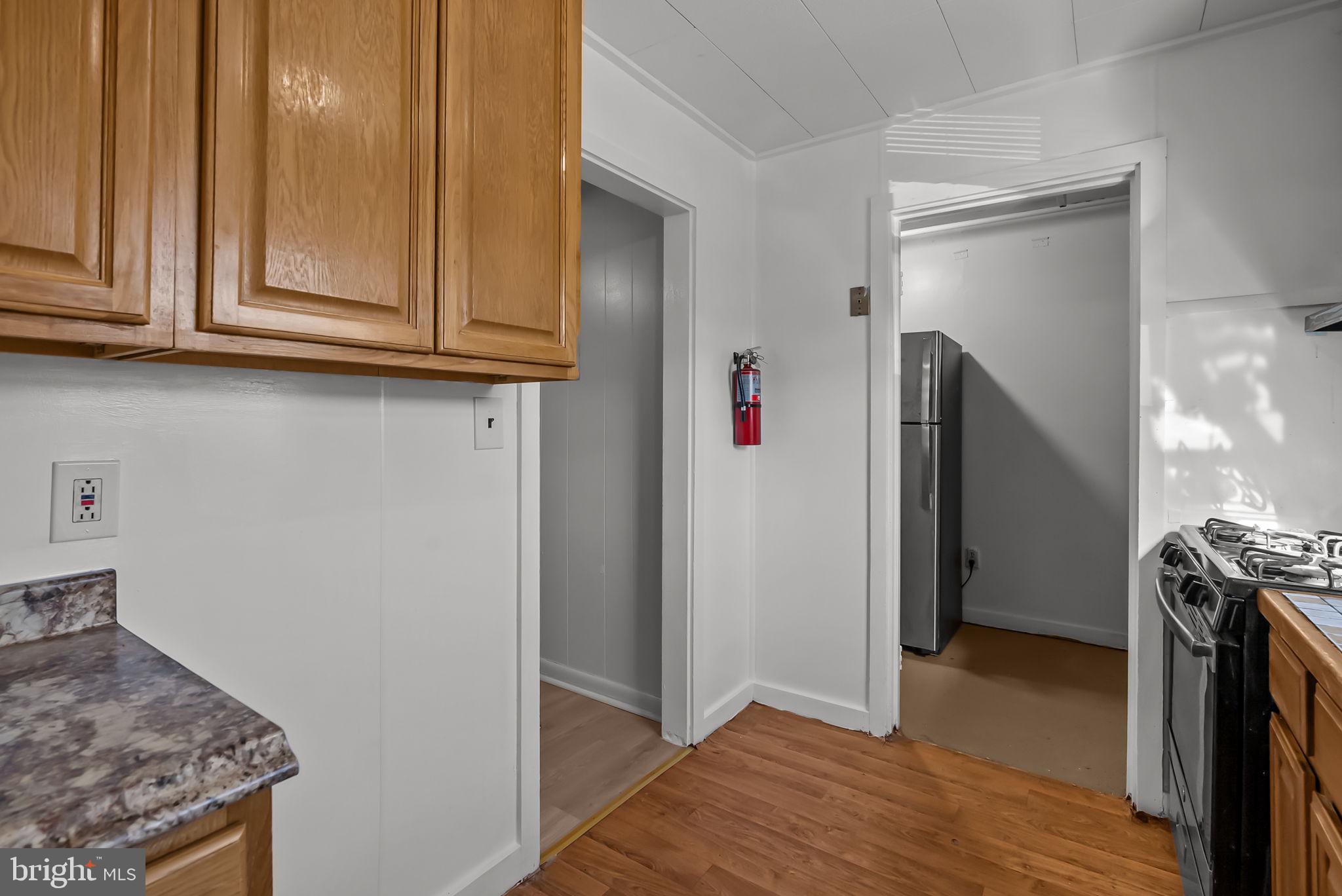 5708 Mitchell Road Levittown, PA 19057 - Photo 15 of 23 a view of a kitchen with fridge and wooden floor
