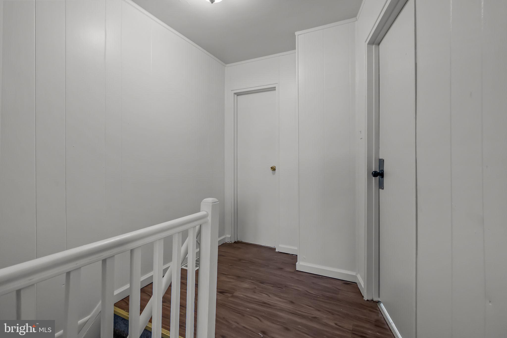 5708 Mitchell Road Levittown, PA 19057 - Photo 18 of 23 a view of a hallway with wooden floor