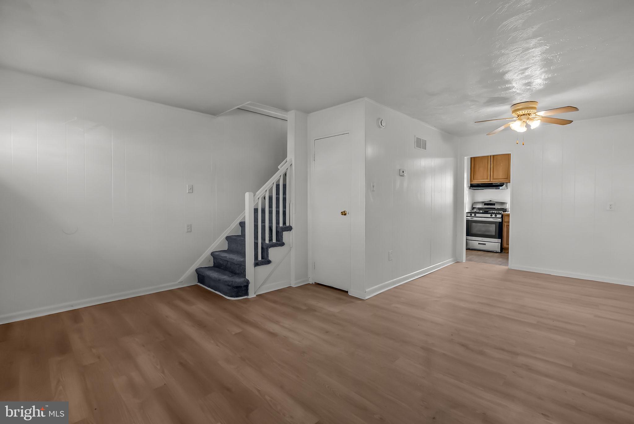 5708 Mitchell Road Levittown, PA 19057 - Photo 4 of 23 a view of an empty room with stairs and wooden floor