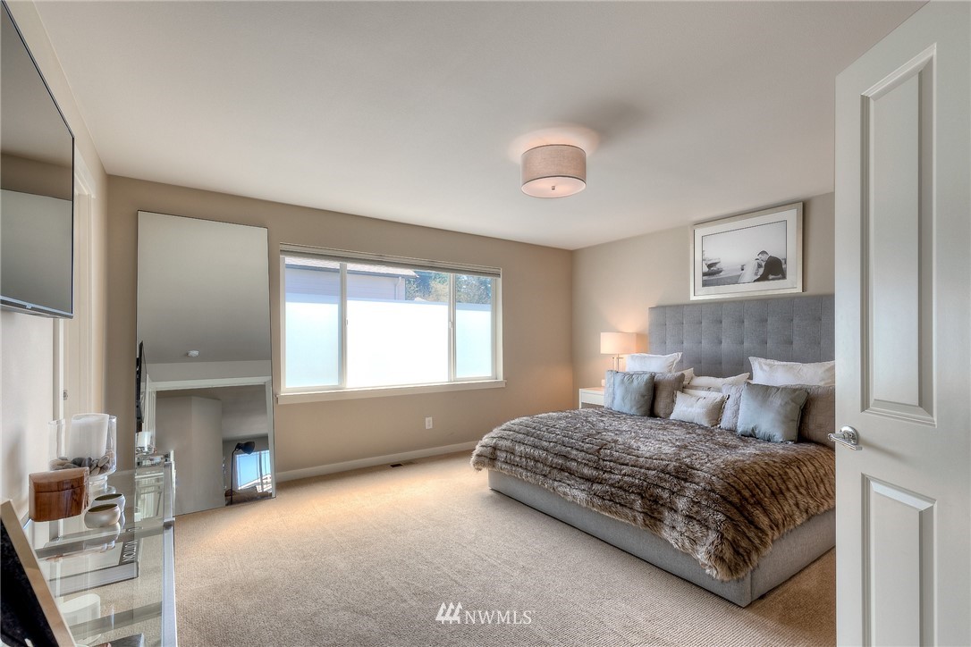 26 175th Place Southwest Bothell, WA 98012 - Photo 14 of 27 a bedroom with a bed and a chandelier