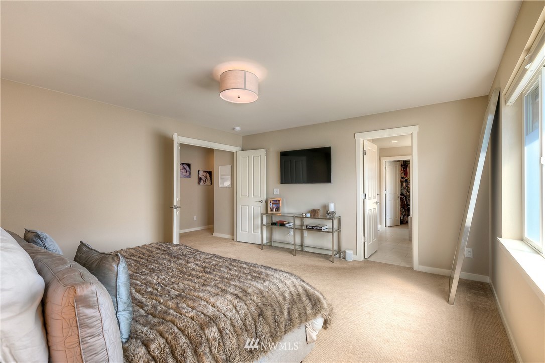 26 175th Place Southwest Bothell, WA 98012 - Photo 15 of 27 a bedroom with a bed and a flat screen tv