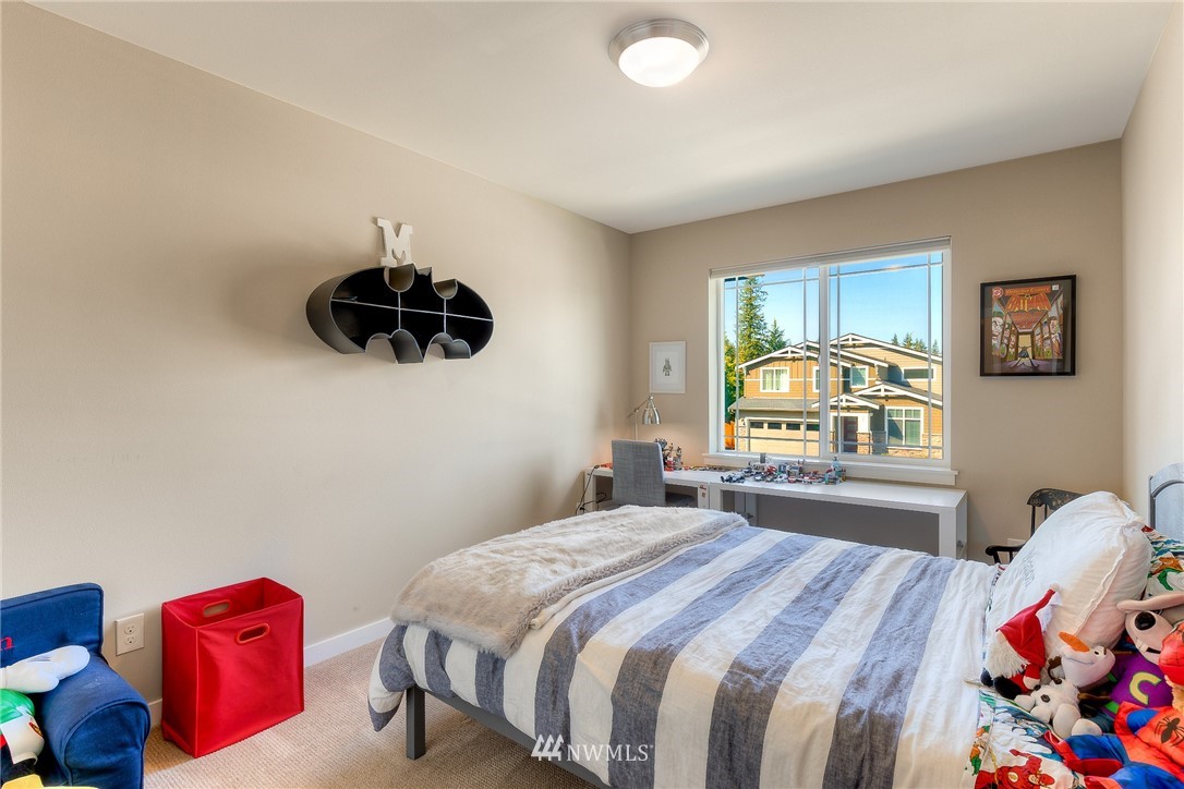 26 175th Place Southwest Bothell, WA 98012 - Photo 19 of 27 a bedroom with a bed and a chandelier