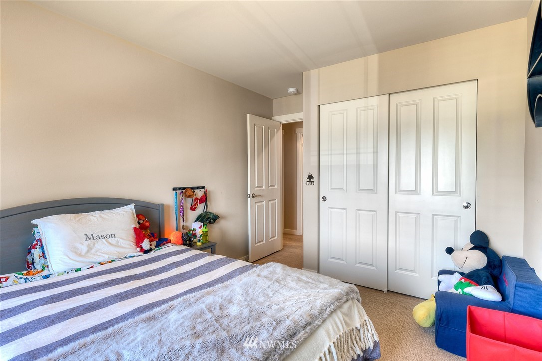 26 175th Place Southwest Bothell, WA 98012 - Photo 20 of 27 a bedroom with a bed and a chandelier