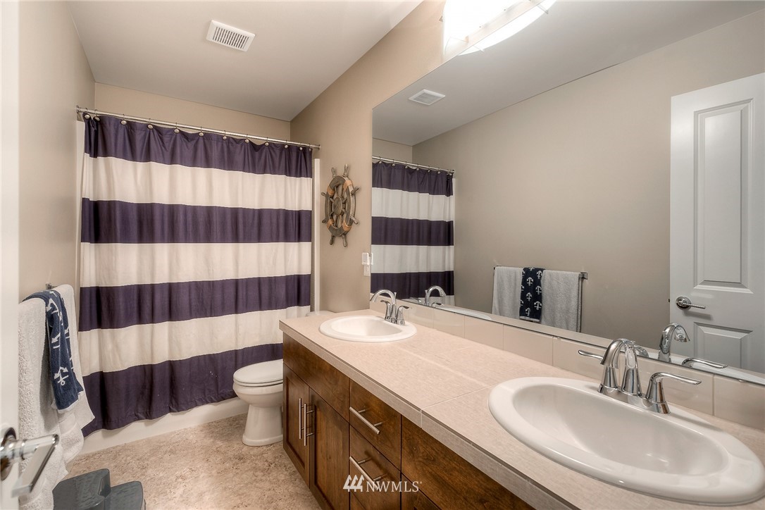 26 175th Place Southwest Bothell, WA 98012 - Photo 22 of 27 a bathroom with a sink a toilet a shower and a mirror