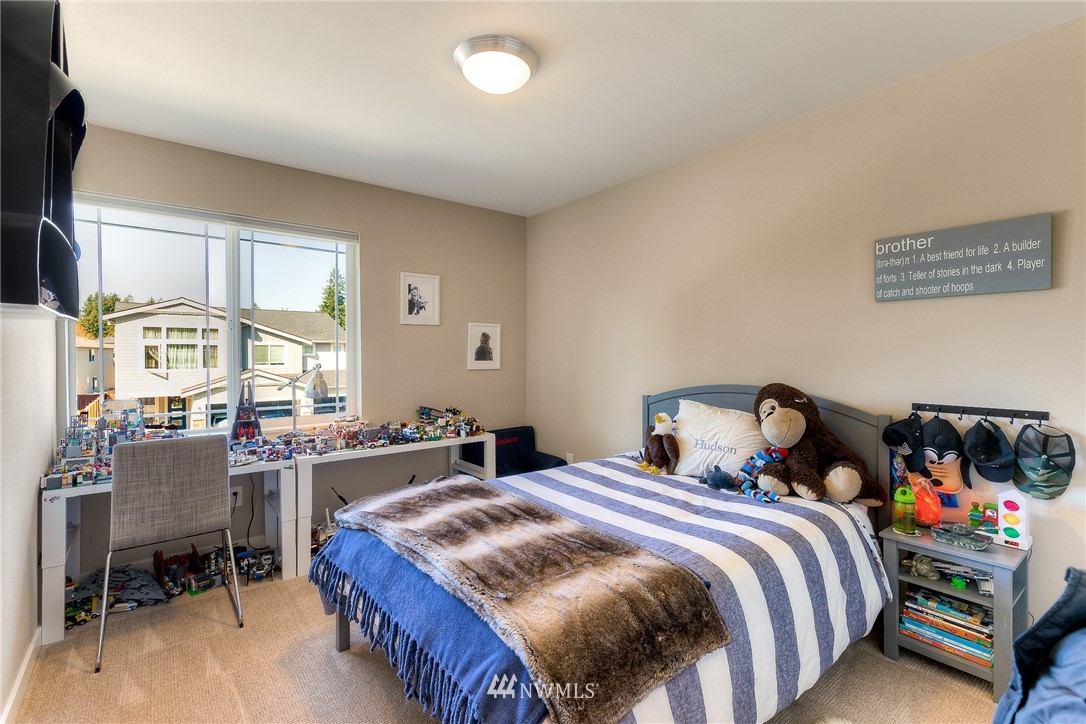 26 175th Place Southwest Bothell, WA 98012 - Photo 23 of 27 a bedroom with a bed and a table in it
