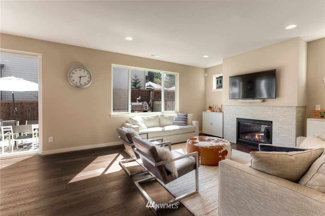 26 175th Place Southwest Bothell, WA 98012 - Photo 5 of 27 a living room with furniture a fireplace and a flat screen tv