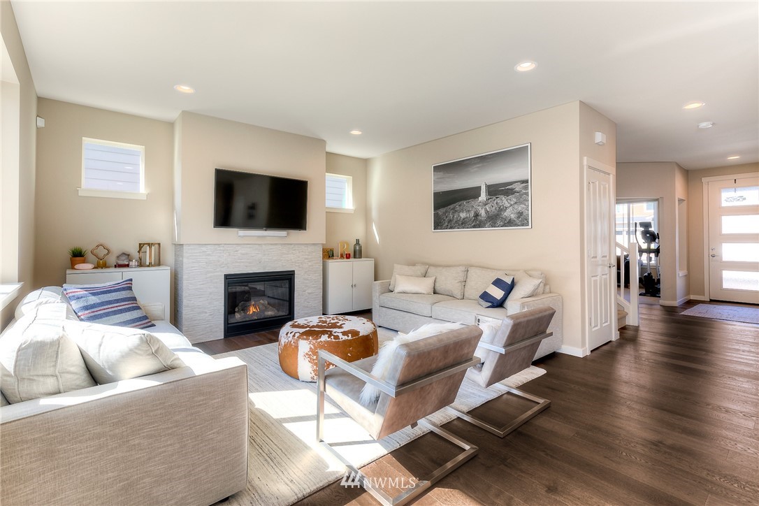 26 175th Place Southwest Bothell, WA 98012 - Photo 8 of 27 a living room with furniture a flat screen tv and a fireplace