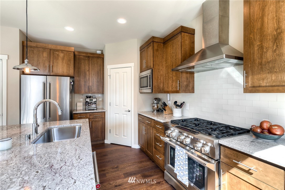 26 175th Place Southwest Bothell, WA 98012 - Photo 10 of 27 a kitchen with granite countertop a stove sink and refrigerator