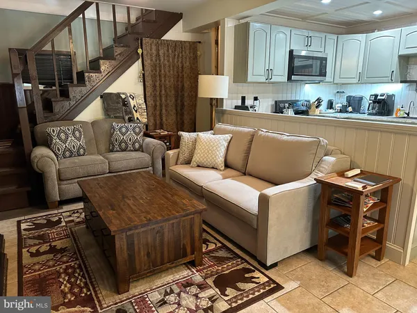 a living room with furniture and a rug