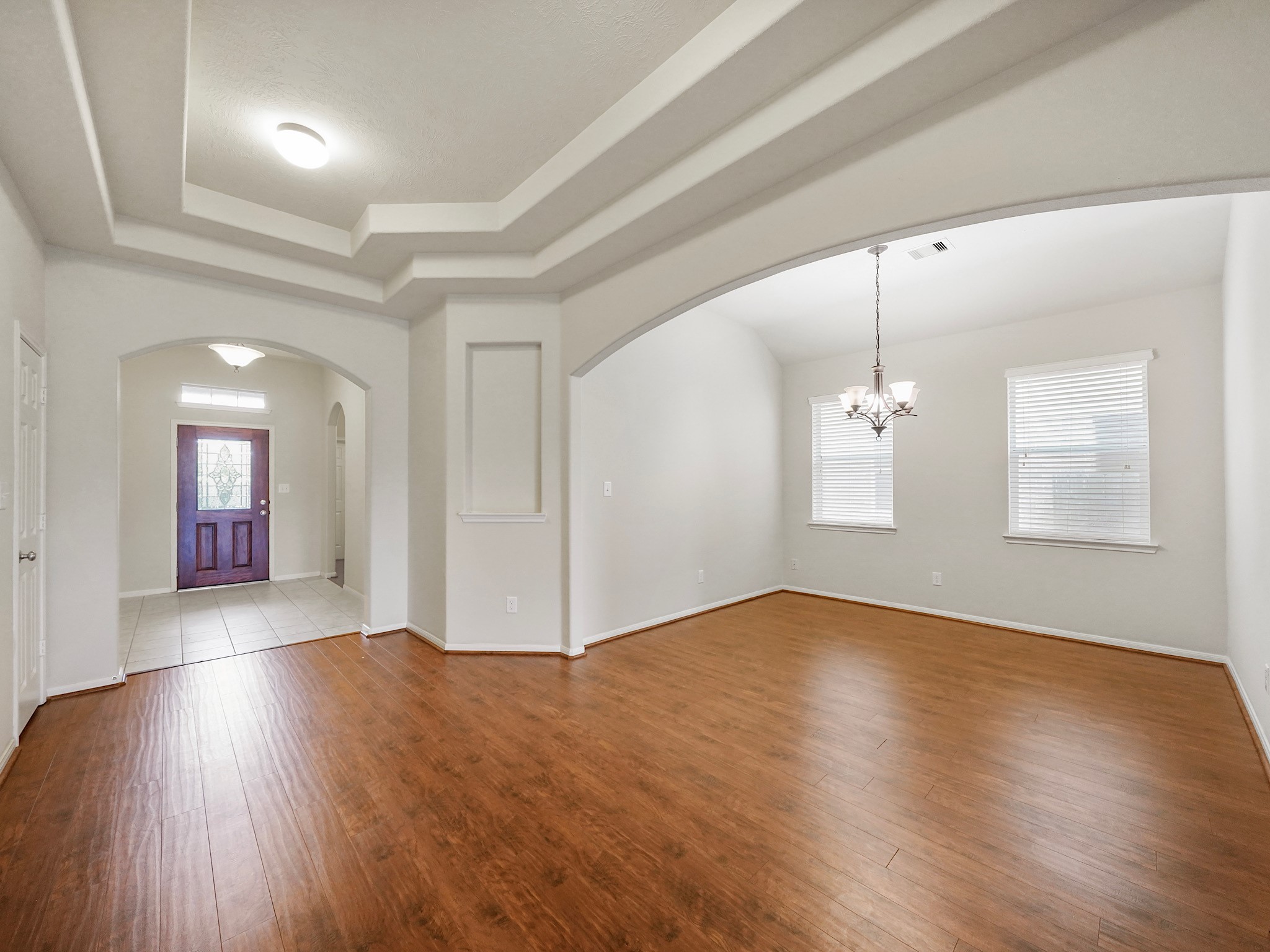 3218 Bandera Run Lane Katy, TX 77494 - Photo 2 of 15 Beautiful formal dining room radiates elegance with the stately arched entryway and stunning light fixture.