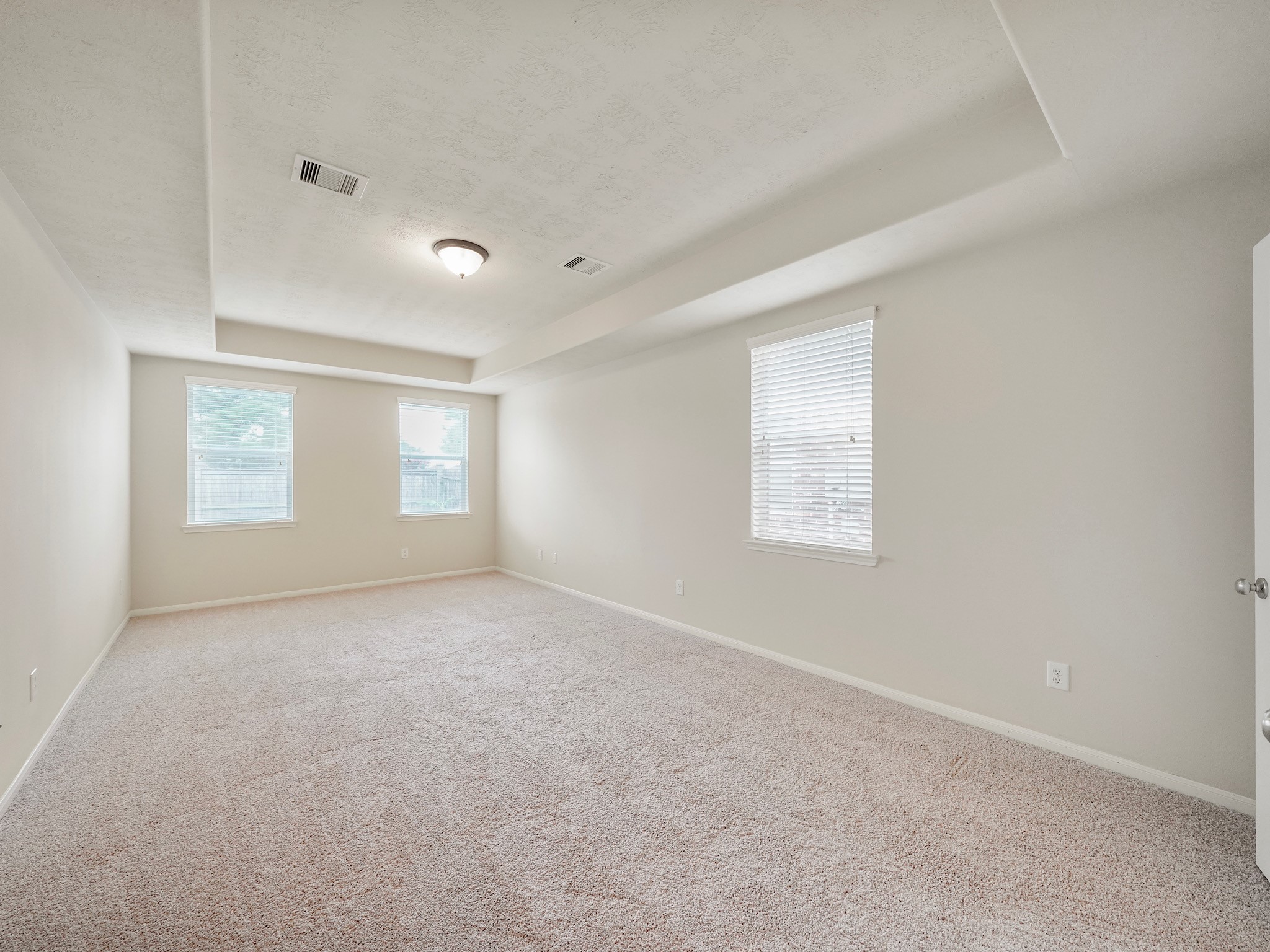 3218 Bandera Run Lane Katy, TX 77494 - Photo 9 of 15 Experience luxury living in this stunning primary retreat with ensuite, complete with a stylish tray ceiling that adds a touch of elegance. The bedrooms boast brand new carpeting, creating a cozy and inviting atmosphere that you'll love coming home to.