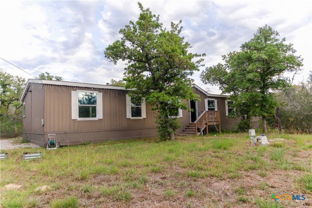 293 Turkey Tree Trail Seguin, TX 78155 - Photo 2 of 9 a backyard of a house with table and chairs