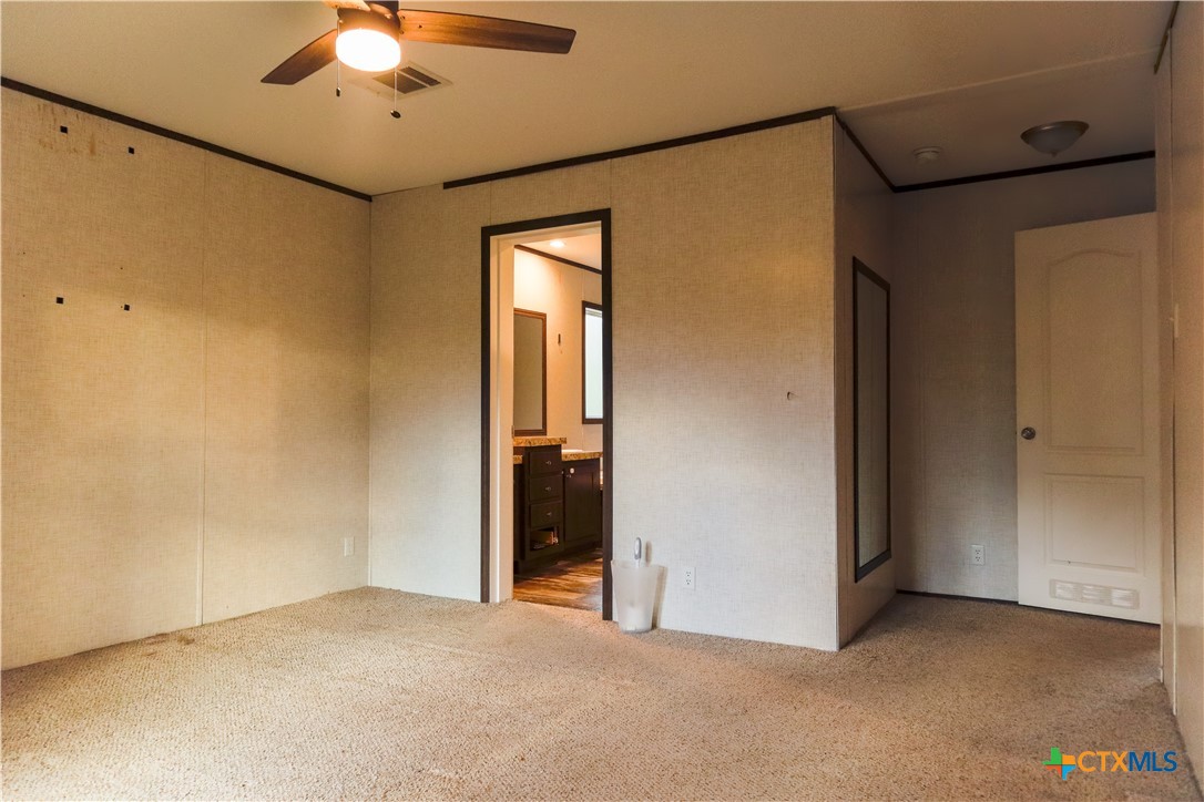 293 Turkey Tree Trail Seguin, TX 78155 - Photo 8 of 9 an empty room with chandelier fan