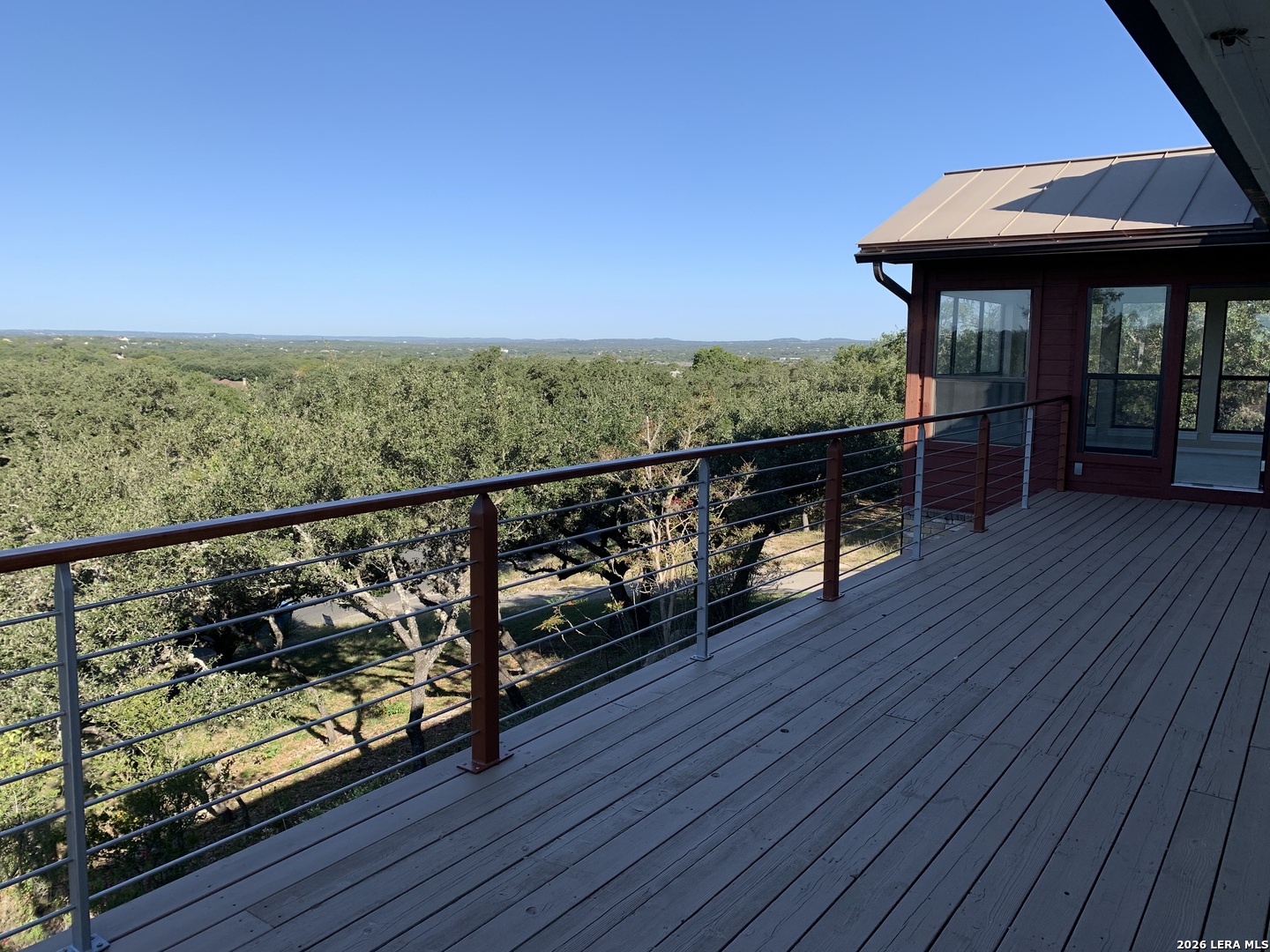 Undisclosed Address Fair Oaks Ranch, TX 78015 - Photo 7 of 12 a view of a balcony with wooden floor and outdoor seating